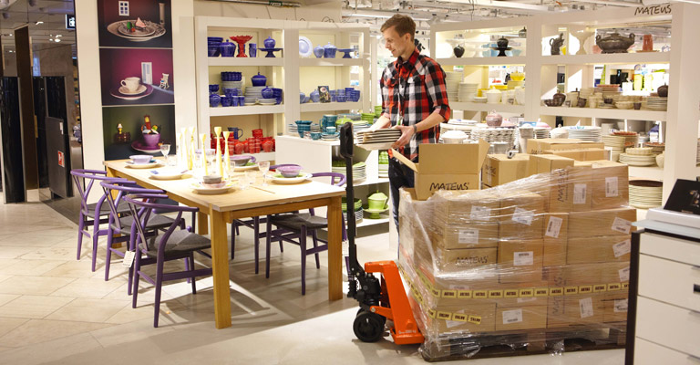 A hand pallet truck being used in a store